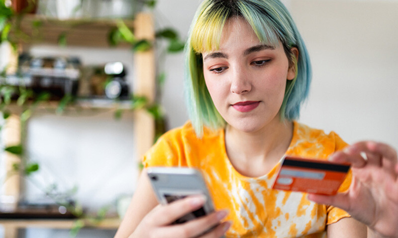 trendy youth making online purchase with credit card